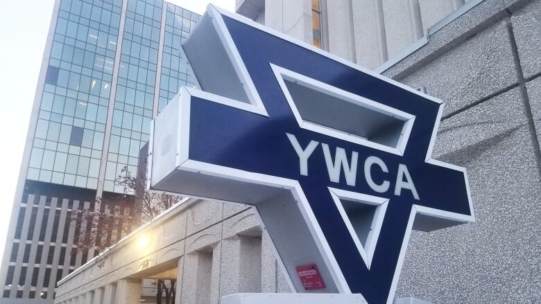 A sign marking the YWCA stands outside a building in downtown Regina.