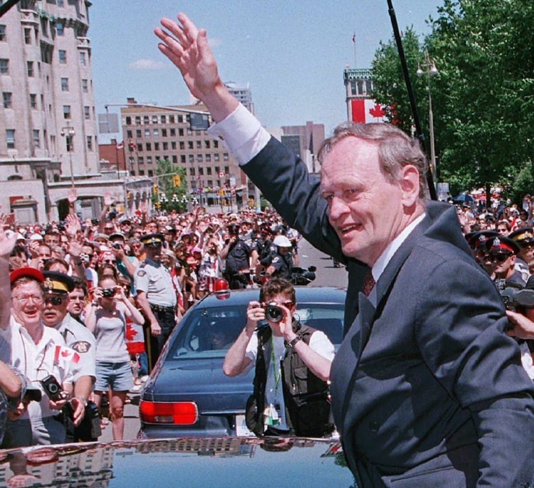 Man waves at crowd 