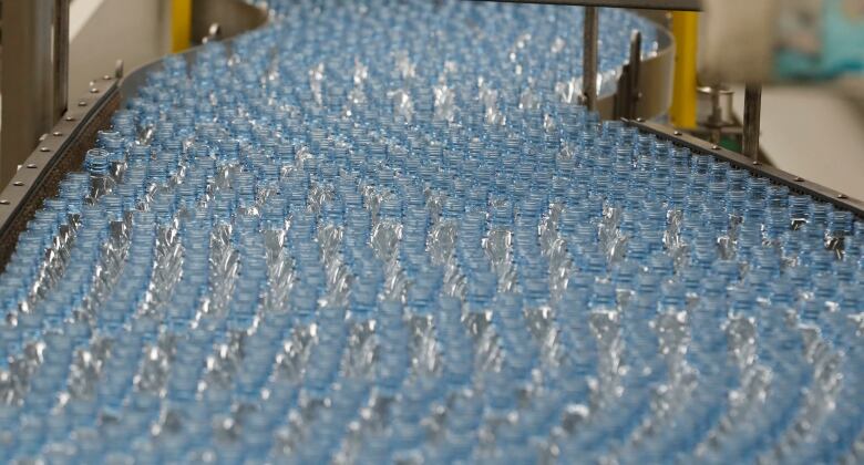 Empty clear plastic bottles on a Coca-Cola bottling plant production line. 