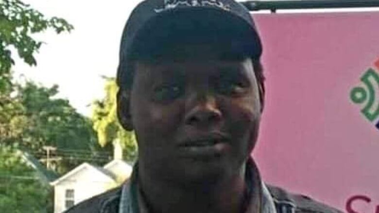 Photo of a south Sudanese man wearing a baseball cap. 