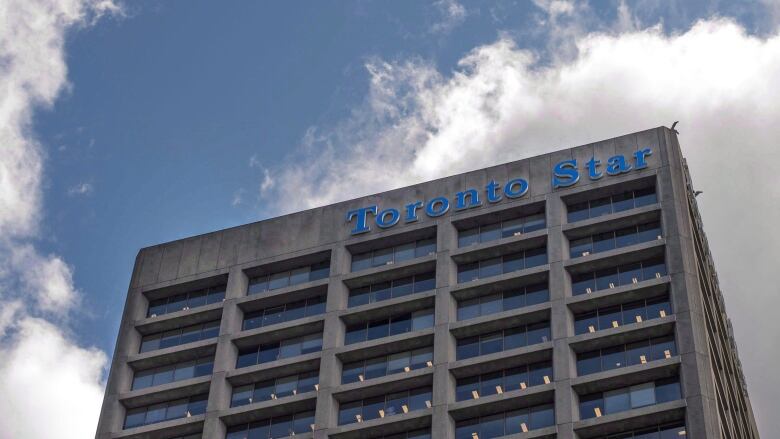 A sign reading 'Toronto Star' is seen on a building.