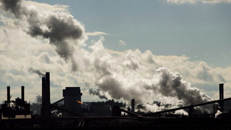 White plumes come from the stacks of steel mills, with Hamilton harbour in the foreground. 