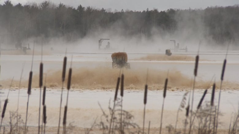 steam rises from a body of water.