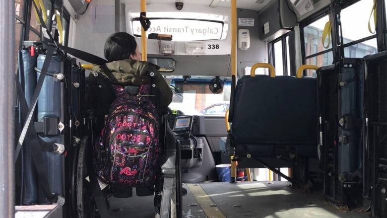 A passenger waits to begin her trip on a Calgary Transit Access bus on March 6, 2019. 