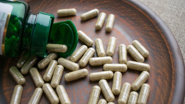 Capsules on a wooden bowl.