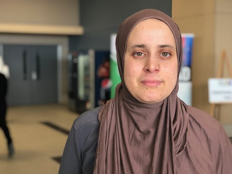 A close-up shot of a woman with a headscarf.