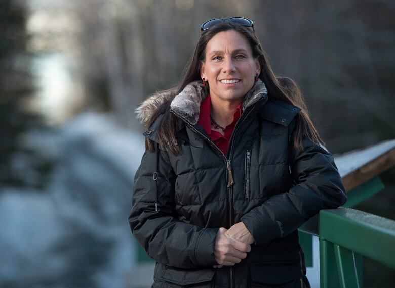 Woman standing outside in jacket and smiling