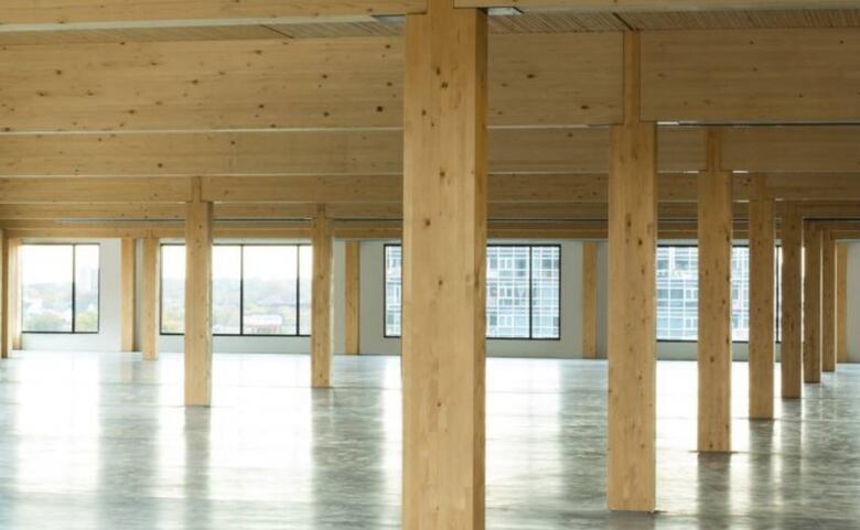 Wood beams and columns are seen in a wood building. 