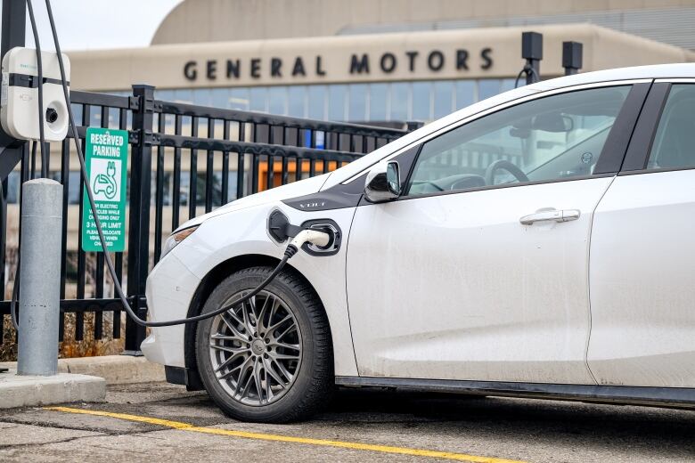 Hybrid 2018 Volt cars at electric vehicle charging stations in the GM lot.