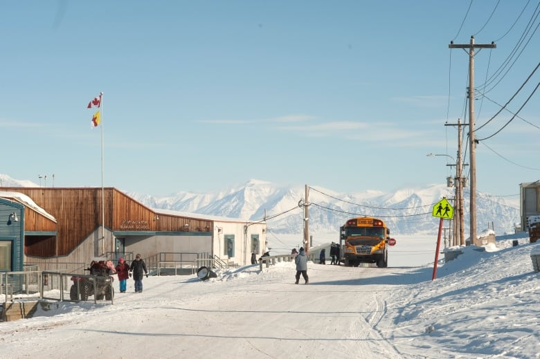 A school bus dropping off kids in a school in the Arctic