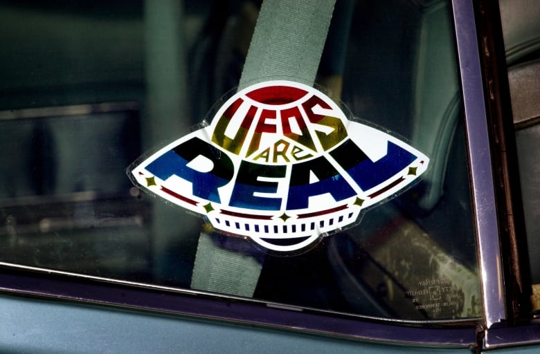 A sticker that says UFOs are real.