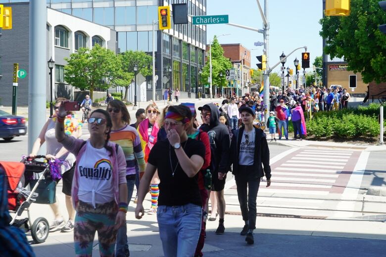 Crowds of people make their way downtown as part of tri-Pride's 2019 Pride March.