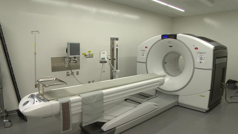 A large white PET-CT scanner.