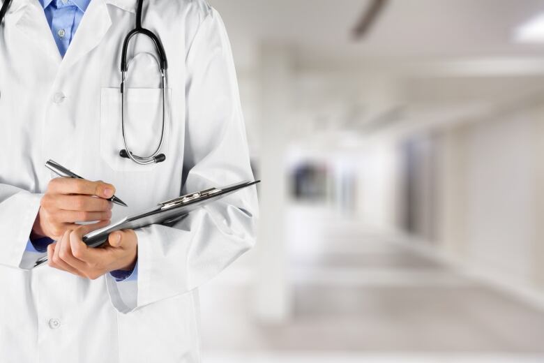 A stock image of a doctor holding a clipboard.