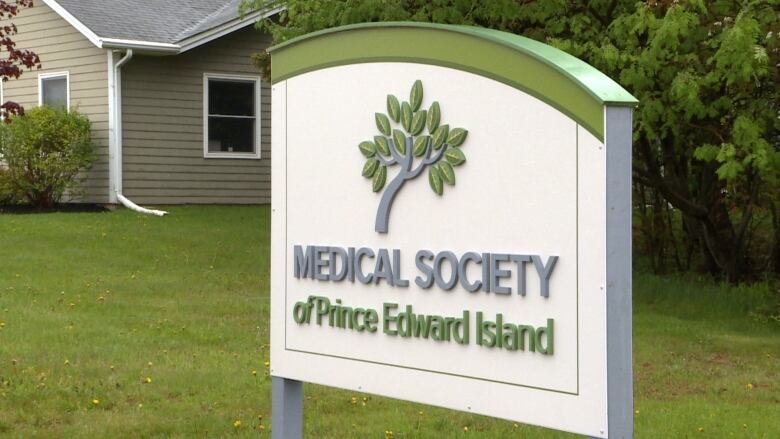 Sign reading Medical Society of Prince Edward Island outside a building with white siding. 