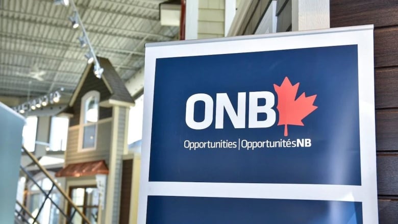 Picture of a blue sign with white lettering and a red maple leaf