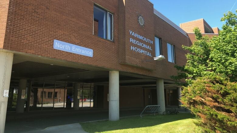 The exterior of a brick building with the words 