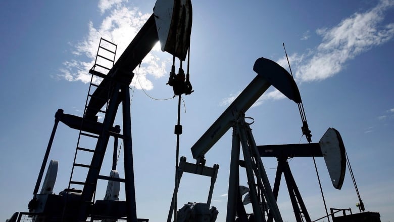 Pumpjacks under blue skies.