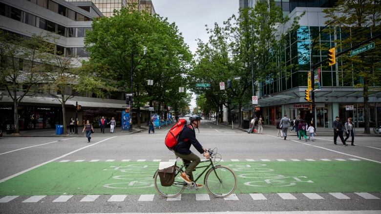 Pedestrians cross in all directions at a new all-walk crosswalk trial at Hornby and Robson in Vancouver, on Thursday, July 4, 2019.