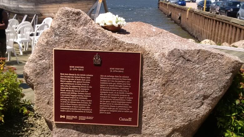 A large rock with a plaque on it