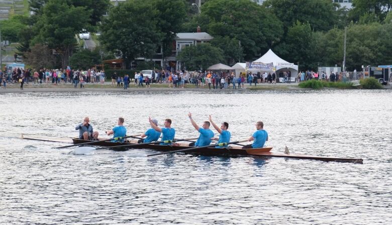 Men rowing in boats around Quidi Vidi Lake