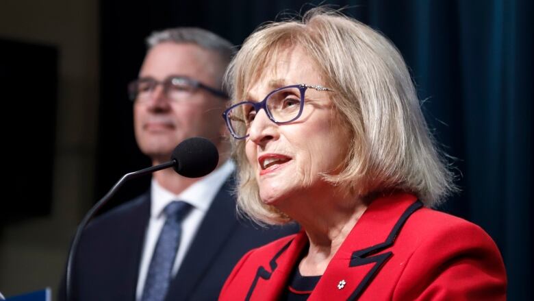 A woman speaks at a podium.