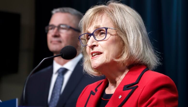 A woman speaks at a podium.