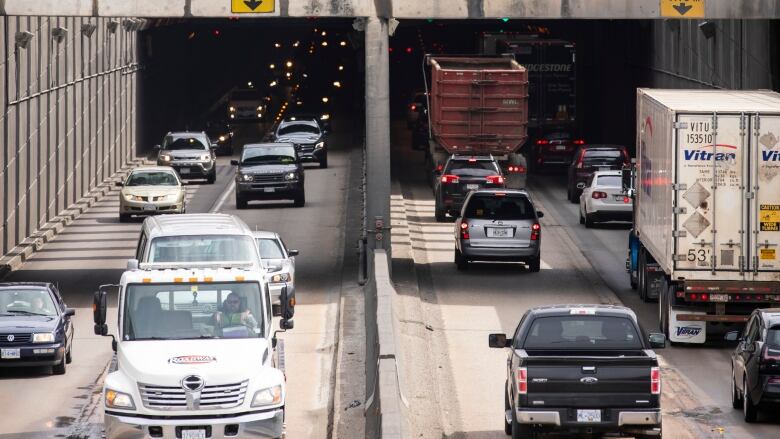 Cars are pictured going in and out of an overpass.