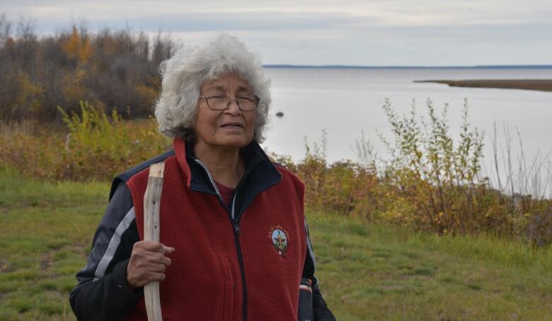 Elder Margaret Leishman on the shore of the Mackenzie River in Kakisa, N.W.T. 