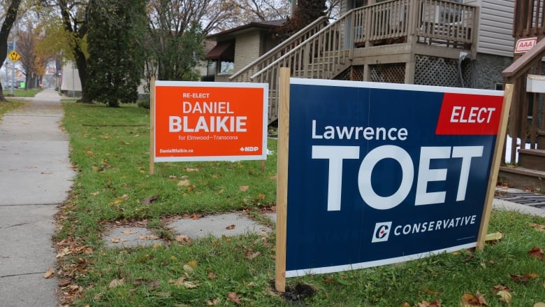 Election signs for former MPs Daniel Blaikie and Lawrence Toet sit on lawns in 2019.