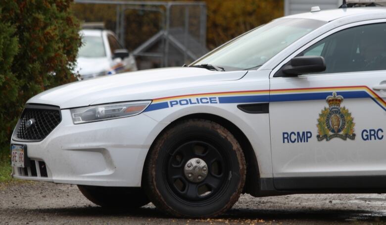 A close up of the front half of a white RCMP sedan police car.