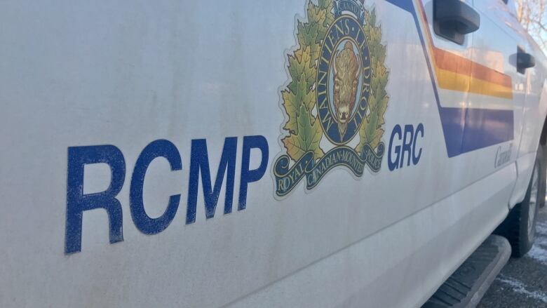 White police car with RCMP logo in blue lettering