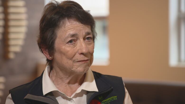 Woman with short brown hair, not smiling.