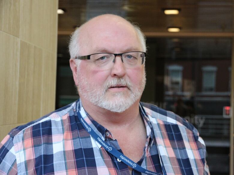 A man wearing glasses and a plaid shirt