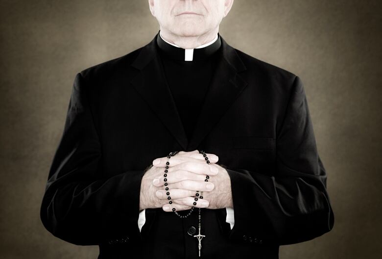 A priest is seen in a stock image