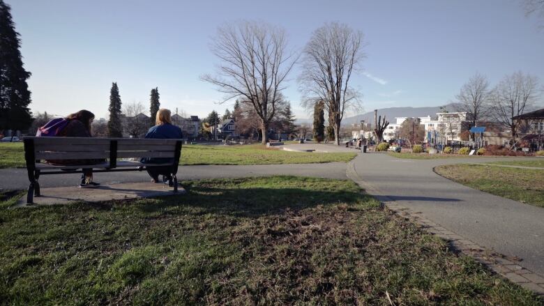 A photo of grandview park, including a bench with two people. 