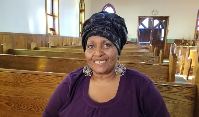 Lana Talbot sitting in a pew inside Sandwich First Baptist Church.