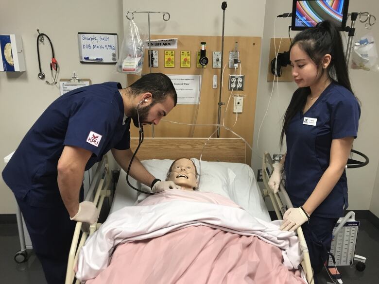 nursing students work on mannequin