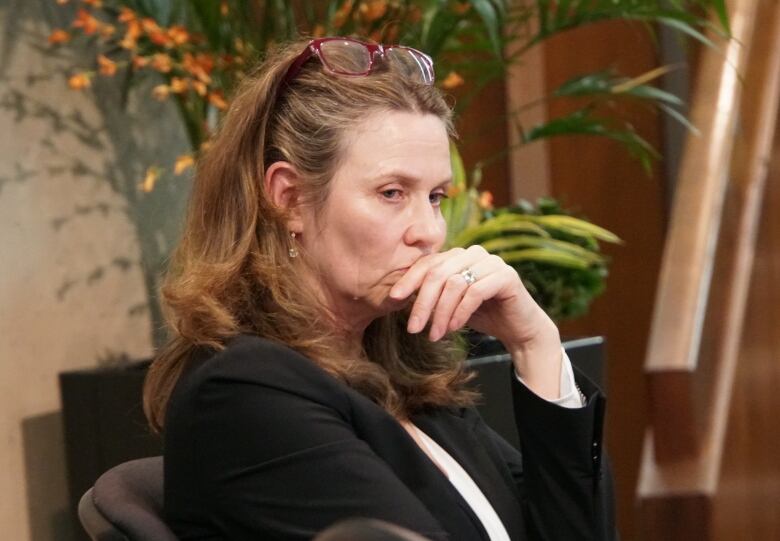 woman sits in council chamber