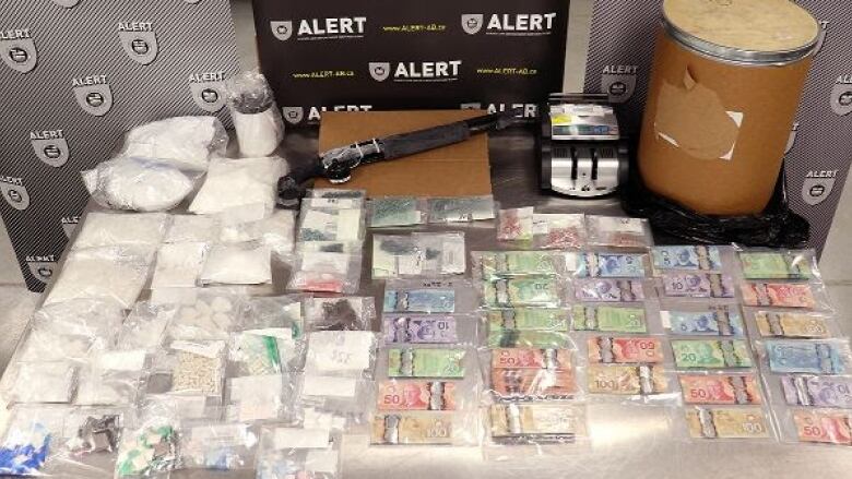 A police photo that appears to show drugs, cash and gun.