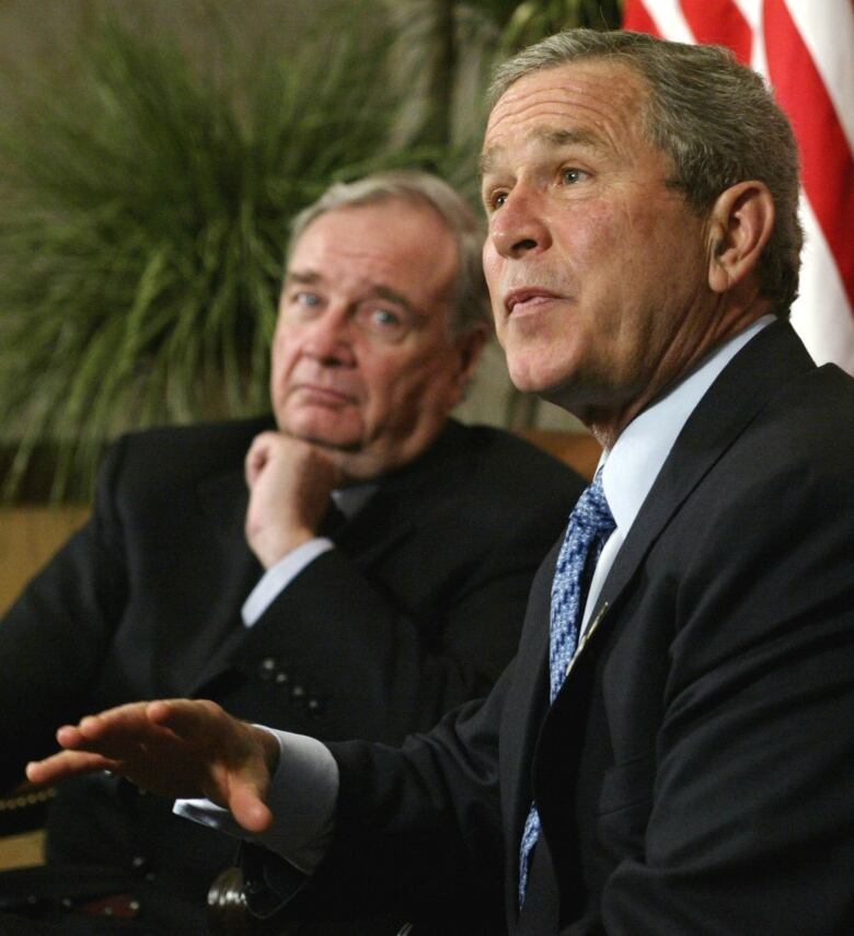 Man looks at other man as he talks