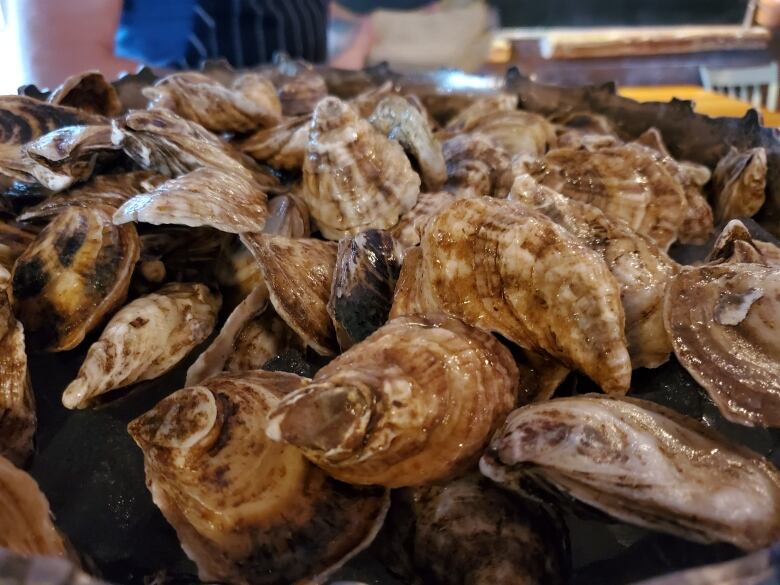 A small pile of oysters is shown.