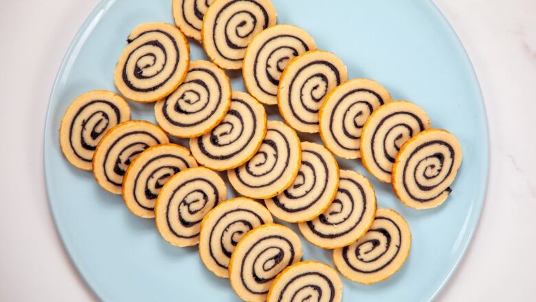 Overhead shot of a plate of Black Sesame Pinwheel pastries.