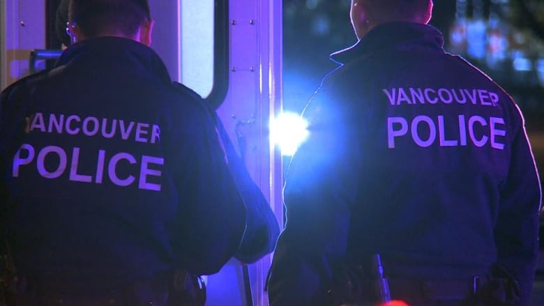 A cop with a jacket that reads 'Vancouver Police'.