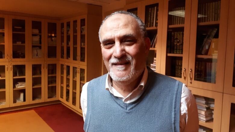 man looking at camera in a library