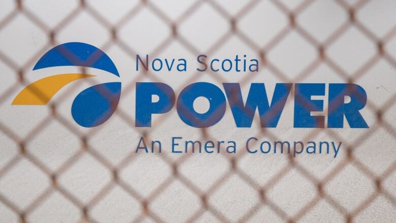 a sign that says Nova Scotia power with a fence in front 