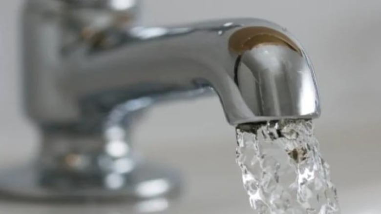 Water pouring out of a tap