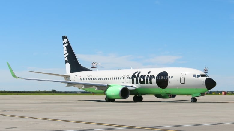 An airplane taxis on a runway during the day.