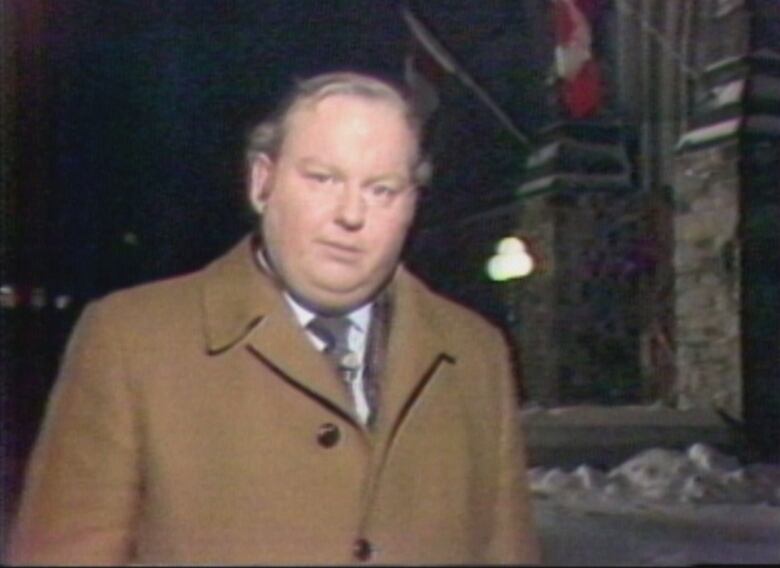 Man standing on Parliament Hill at night