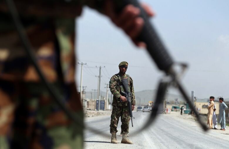 Afghan National Army soldiers stand guard at a checkpoint on the outskirts of Kabul, Afghanistan on April 28, 2019.